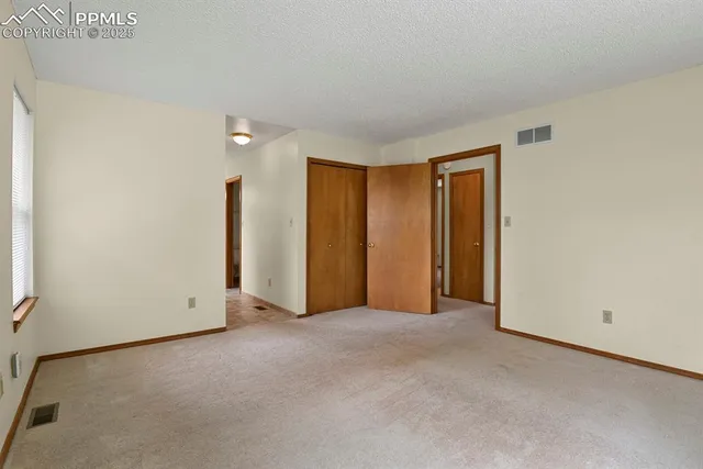a spacious bathroom with a double vanity sink a mirror and a shower