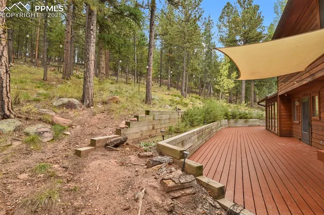 a view of a balcony with wooden floor and fence
