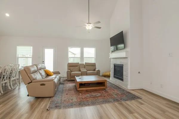 a living room with furniture a fireplace and a flat screen tv