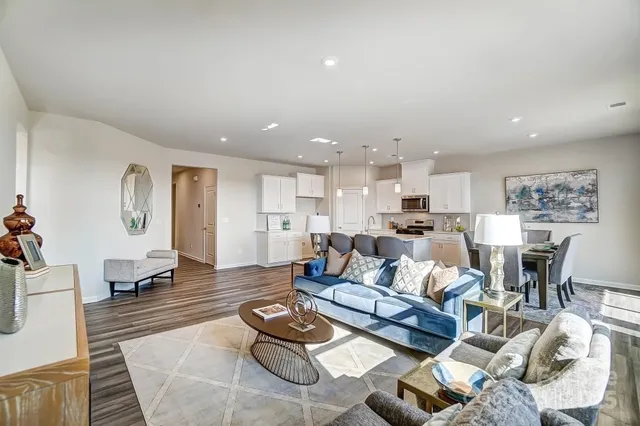 a living room with furniture kitchen view and a table