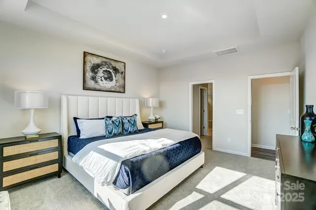 a bedroom with a bed and a lamp on table