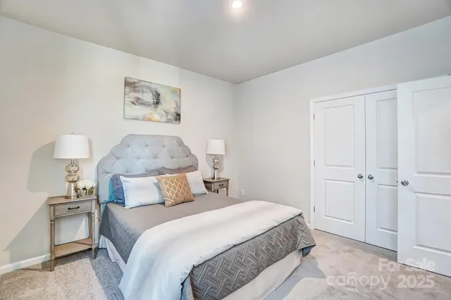 a bedroom with a bed and a painting