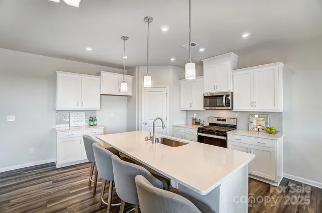 a kitchen with kitchen island wooden cabinets and white appliances
