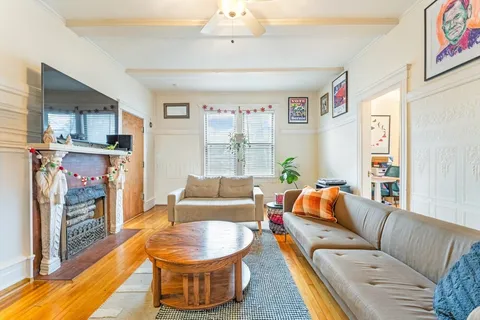 a living room with furniture and a chandelier