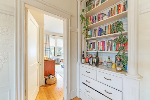 a room with book shelf and a window