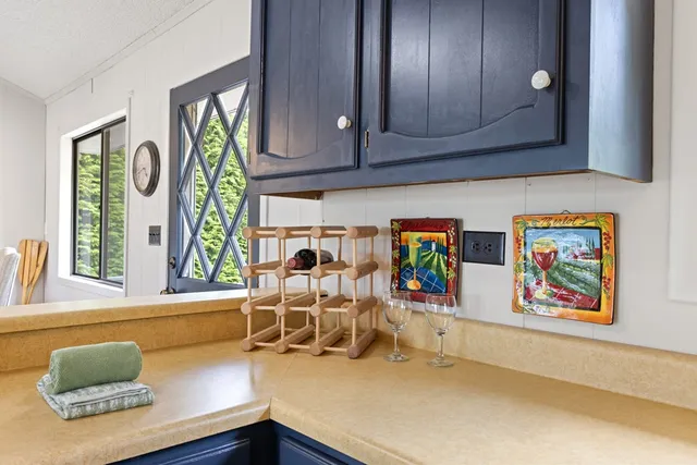 a living room with furniture and painting on the wall