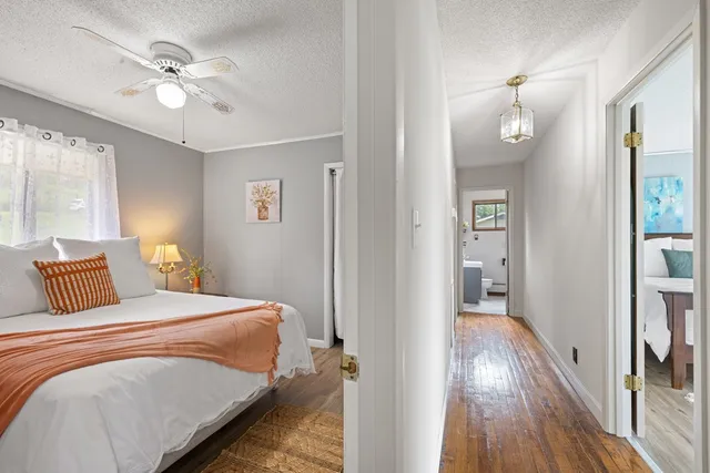 a bedroom with a bed and wooden floor
