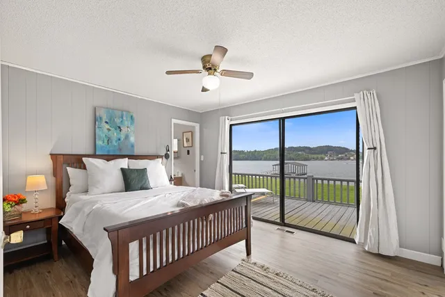 a bedroom with a large bed and a large window