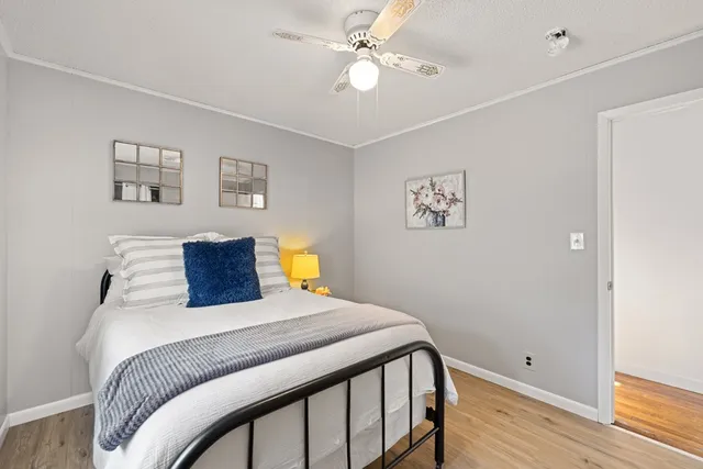 a bedroom with a bed and wooden floor