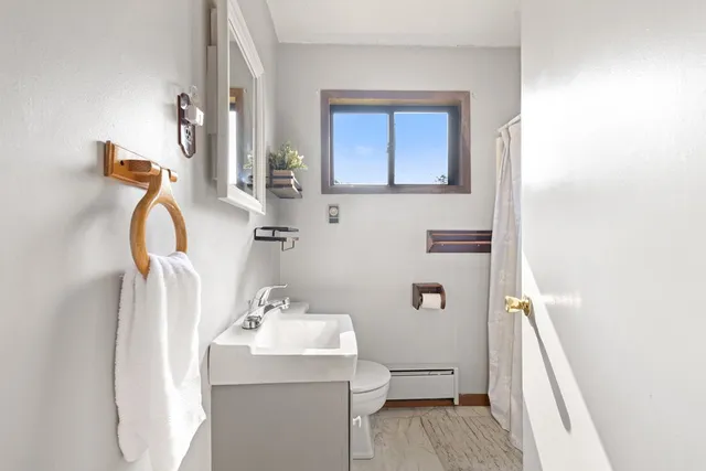 a bathroom with a sink toilet and mirror