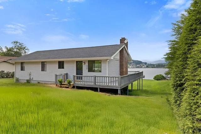 a view of a house with a yard and sitting area