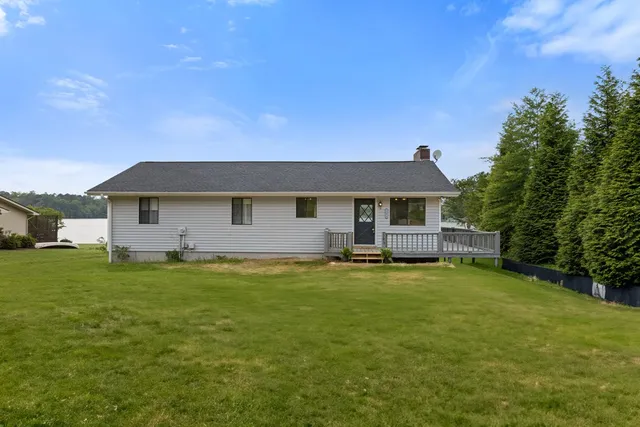 a front view of a house with a garden and porch