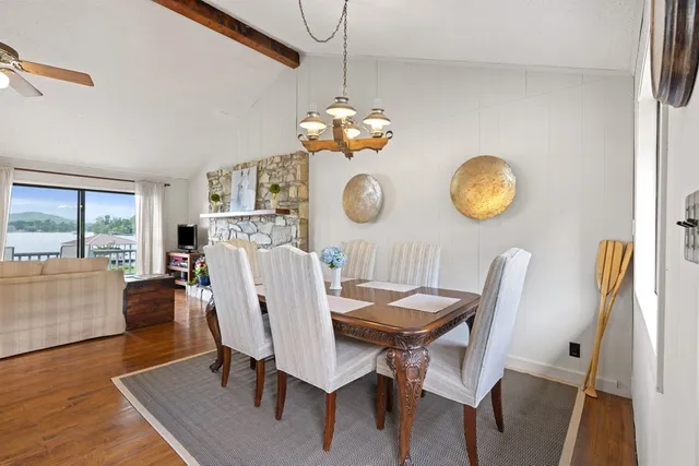 a view of a dining room with furniture and chandelier