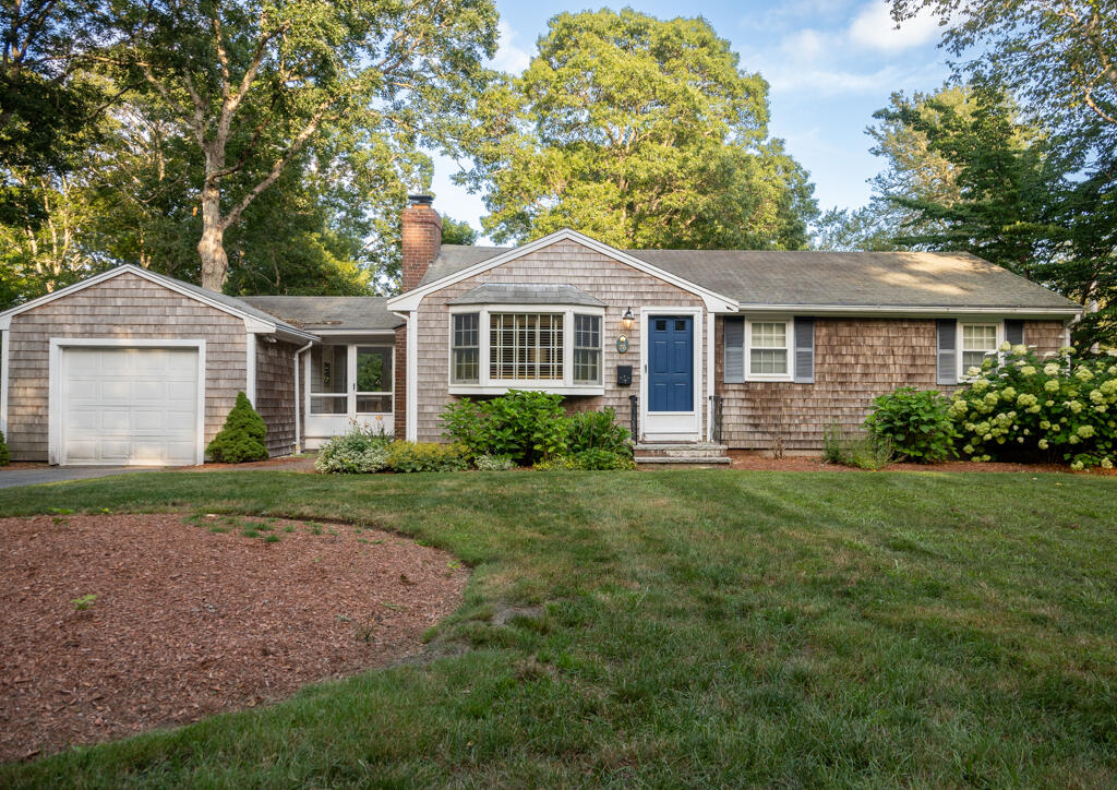 76 Longfellow Drive Centerville, MA 02632 - Photo 1 of 18 a front view of a house with a yard and garage