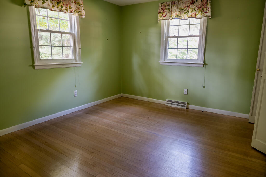 76 Longfellow Drive Centerville, MA 02632 - Photo 13 of 18 an empty room with wooden floor and windows