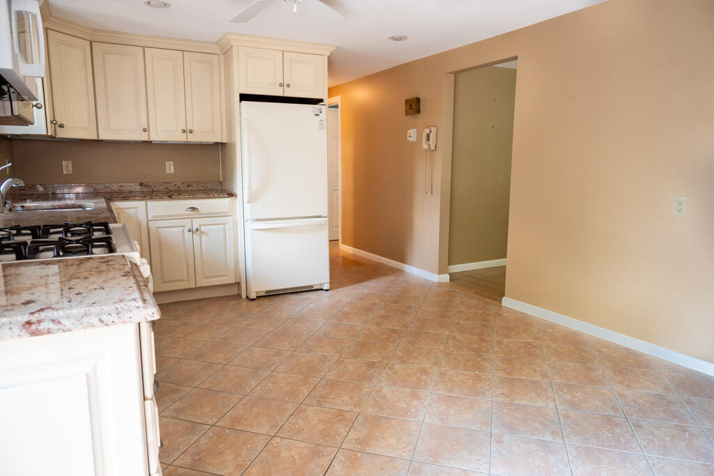 76 Longfellow Drive Centerville, MA 02632 - Photo 7 of 18 a kitchen with a refrigerator sink stove and cabinets