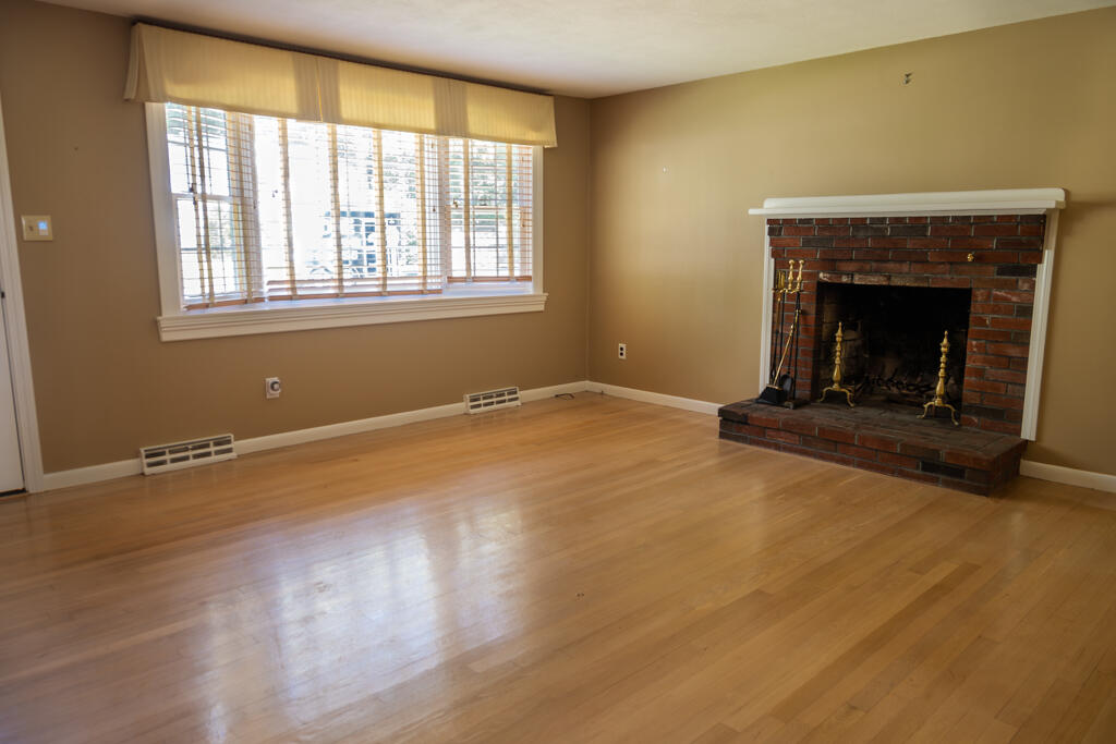 76 Longfellow Drive Centerville, MA 02632 - Photo 8 of 18 a view of empty room with wooden floor and a fireplace