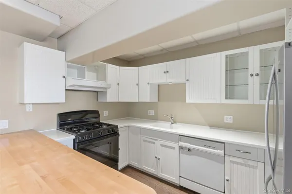 a kitchen with a sink stove and cabinets