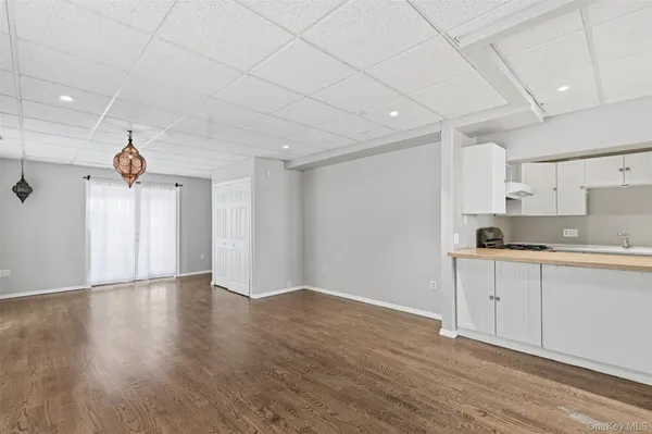 a view of kitchen with a sink wooden floor and window