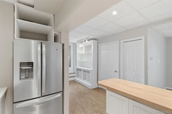 a kitchen with stainless steel appliances a refrigerator and a cabinets