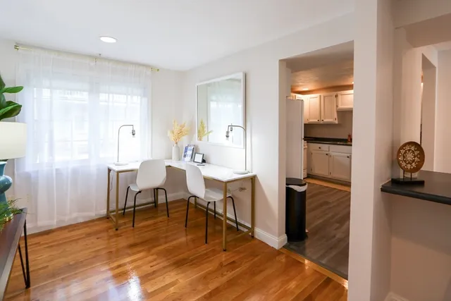 a view of a dining room with furniture window and wooden floor