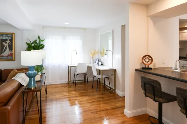a view of a dining room with furniture and wooden floor