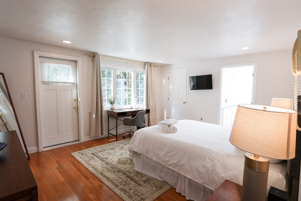 25 Jay Street, Unit FURNISHED Cambridge, MA 02139 - Photo 17 of 28 a bedroom with a bed a window and wooden floor