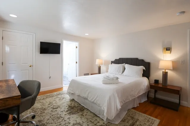 a bedroom with a bed and a chair