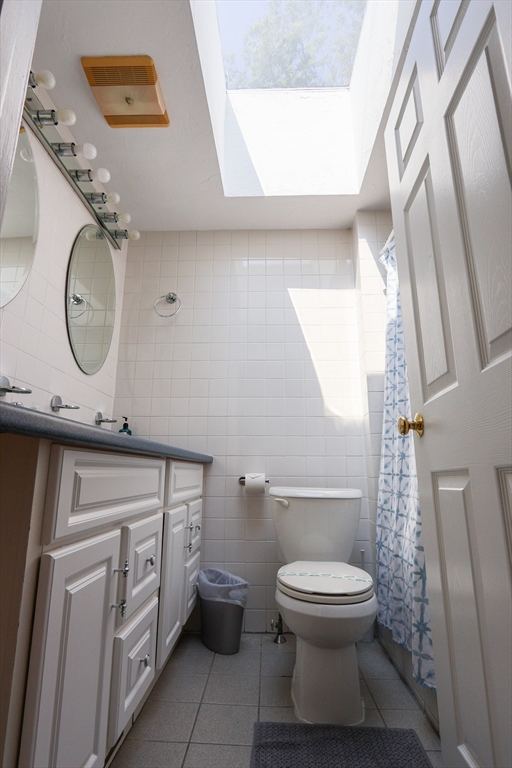 25 Jay Street, Unit FURNISHED Cambridge, MA 02139 - Photo 22 of 28 a bathroom with a toilet a sink and a mirror