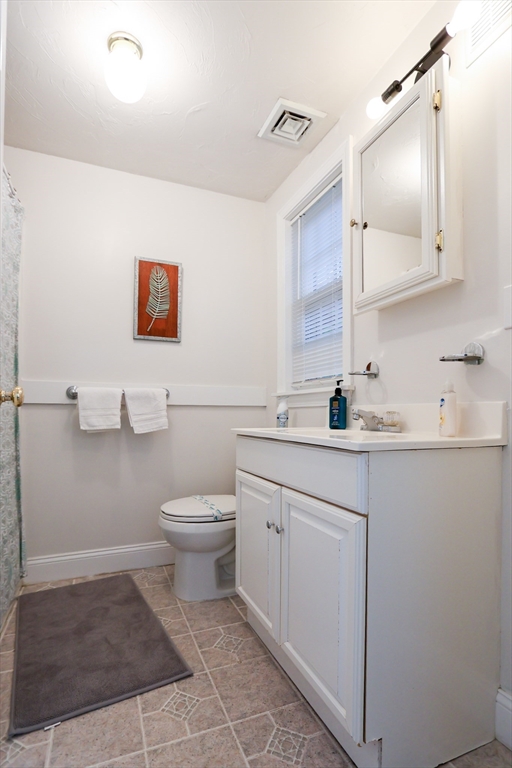 25 Jay Street, Unit FURNISHED Cambridge, MA 02139 - Photo 25 of 28 a bathroom with a toilet a sink and mirror