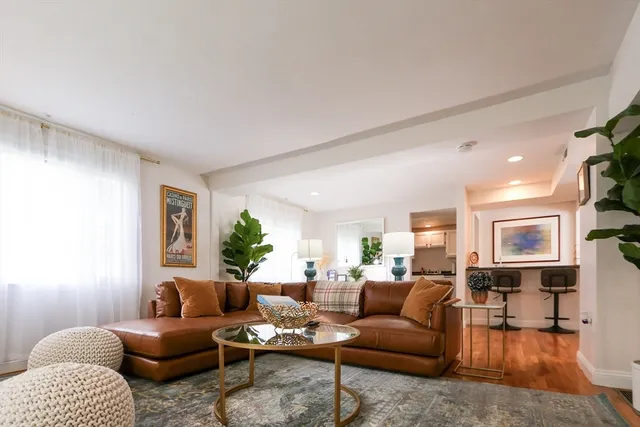 a living room with furniture or couch and a wooden floor