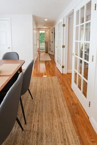 a view of a bedroom with wooden floor and windows