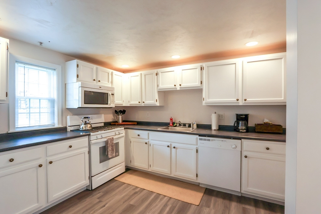25 Jay Street, Unit FURNISHED Cambridge, MA 02139 - Photo 10 of 28 a kitchen with cabinets stainless steel appliances a sink and a window