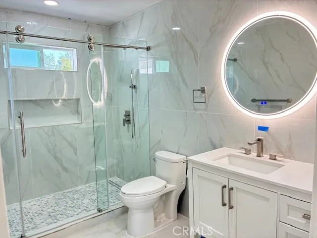 a bathroom with a sink toilet and shower