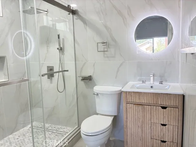 a bathroom with a sink toilet and shower