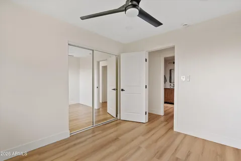 a view of empty room with wooden floor