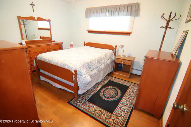 a bedroom with bed and a window