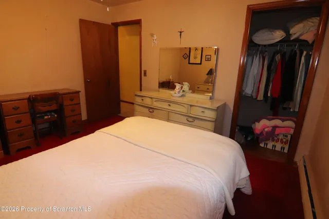 a bedroom with a bed and a closet