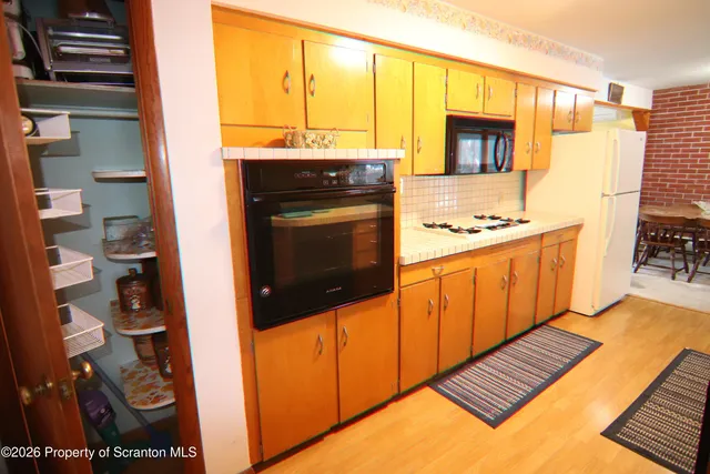 a kitchen with stainless steel appliances a stove a microwave and a refrigerator