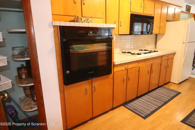 a kitchen with stainless steel appliances a stove a microwave and cabinets