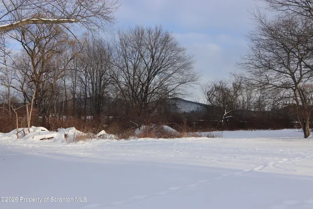 a view of snow on the side of the road