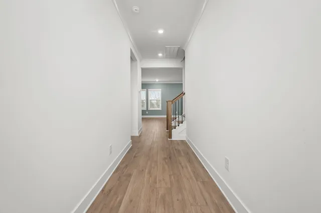 a view of a hallway with wooden floor