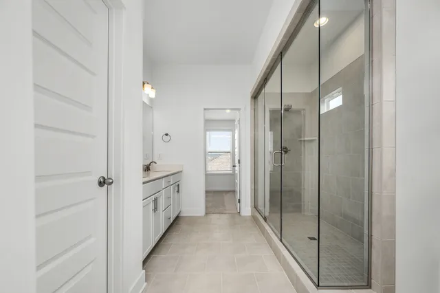 a bathroom with a glass shower door