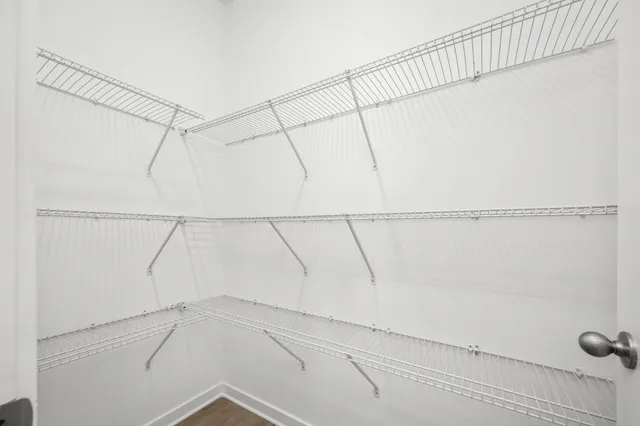 a view of walk in closet with empty racks