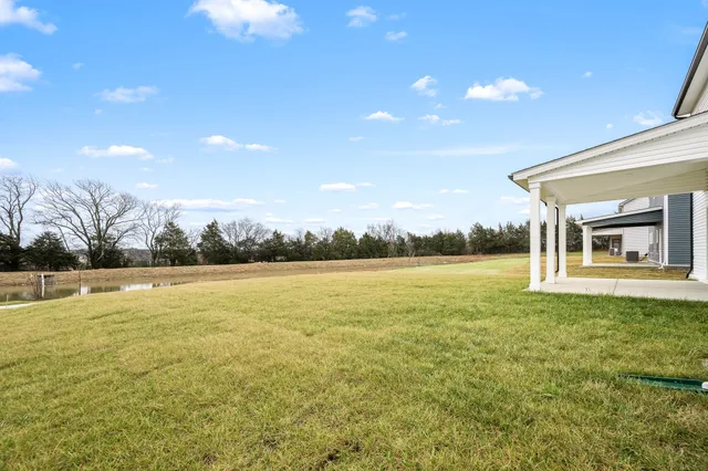 a big white house with a large pool