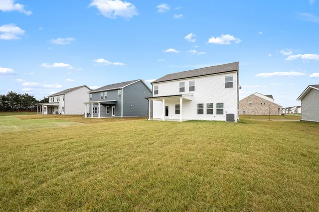 a view of an white house with a swimming pool