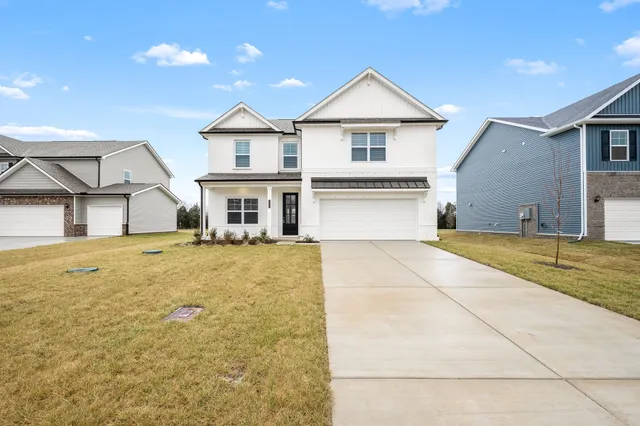 a view of a white house with a swimming pool