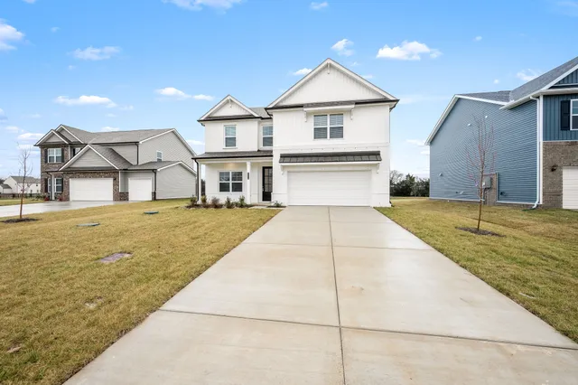 a view of house with outdoor space and sitting area