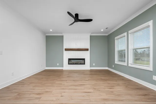 wooden floor in an empty room with a fireplace