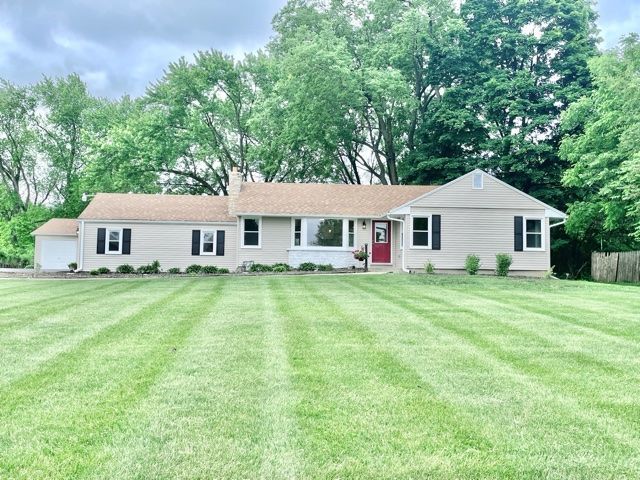 1028 Franklin Grove Road Dixon, IL 61021 - Photo 1 of 48 a front view of a house with a garden